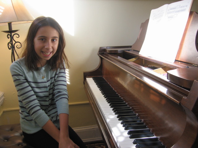 Girl smiling at piano